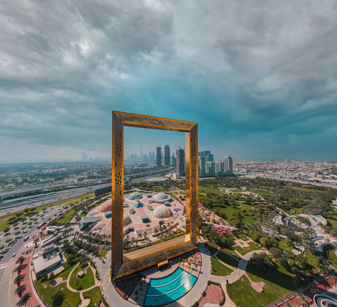 The Dubai Frame standing in a park with the city skyline in Dubai.